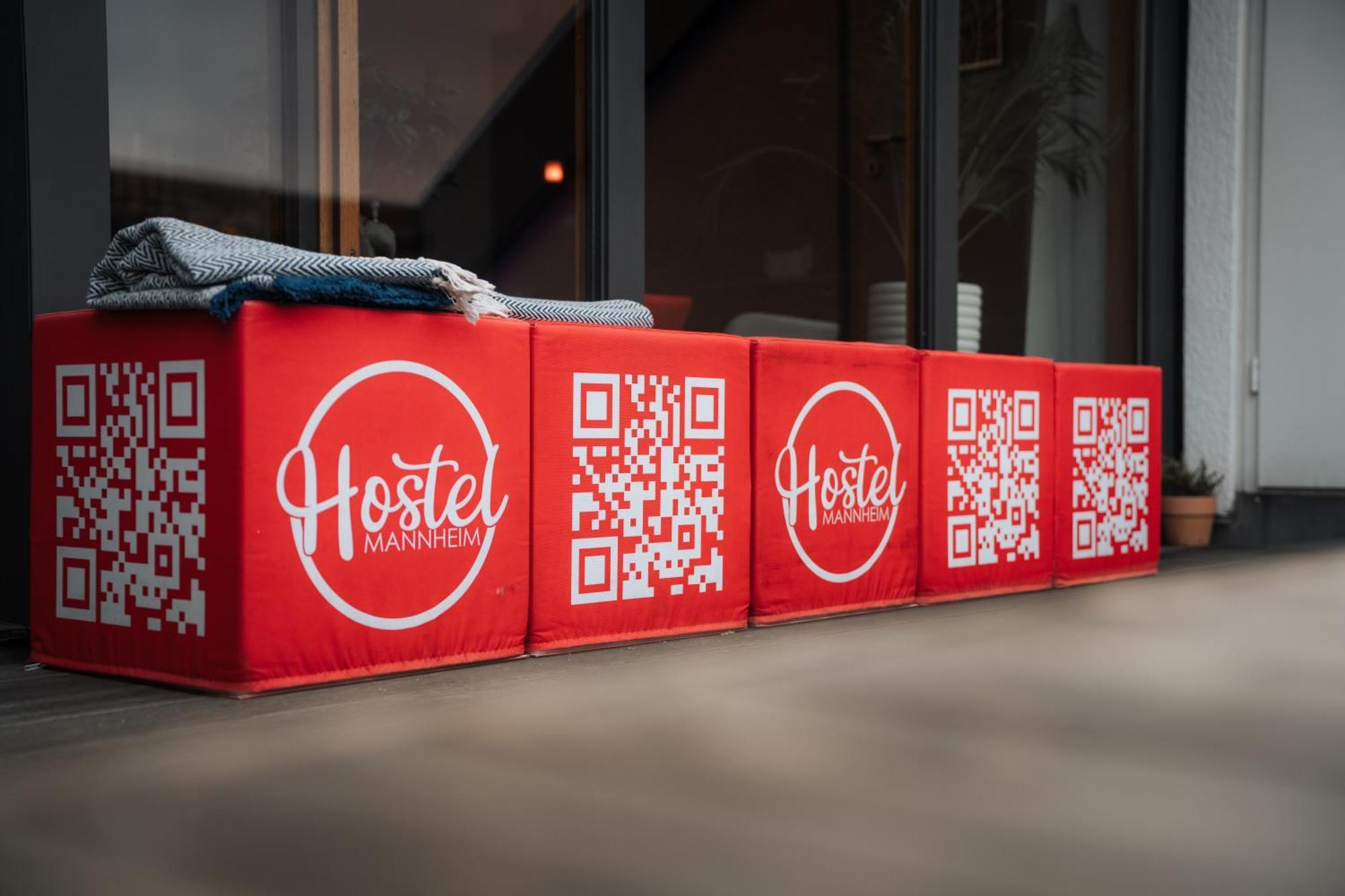 Hostel MHG Exterior photo QR codes on a bench